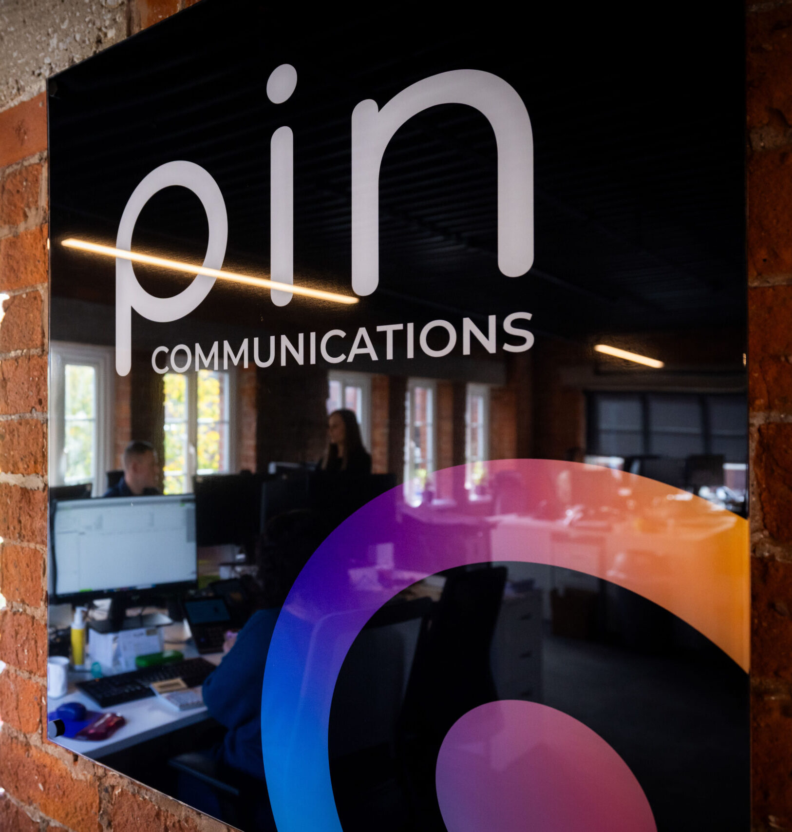 PIN Communications logo in the stockport office